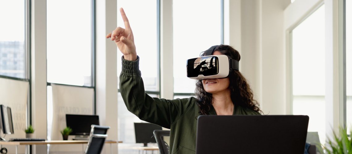 Woman in office wearing VR glasses at meeting